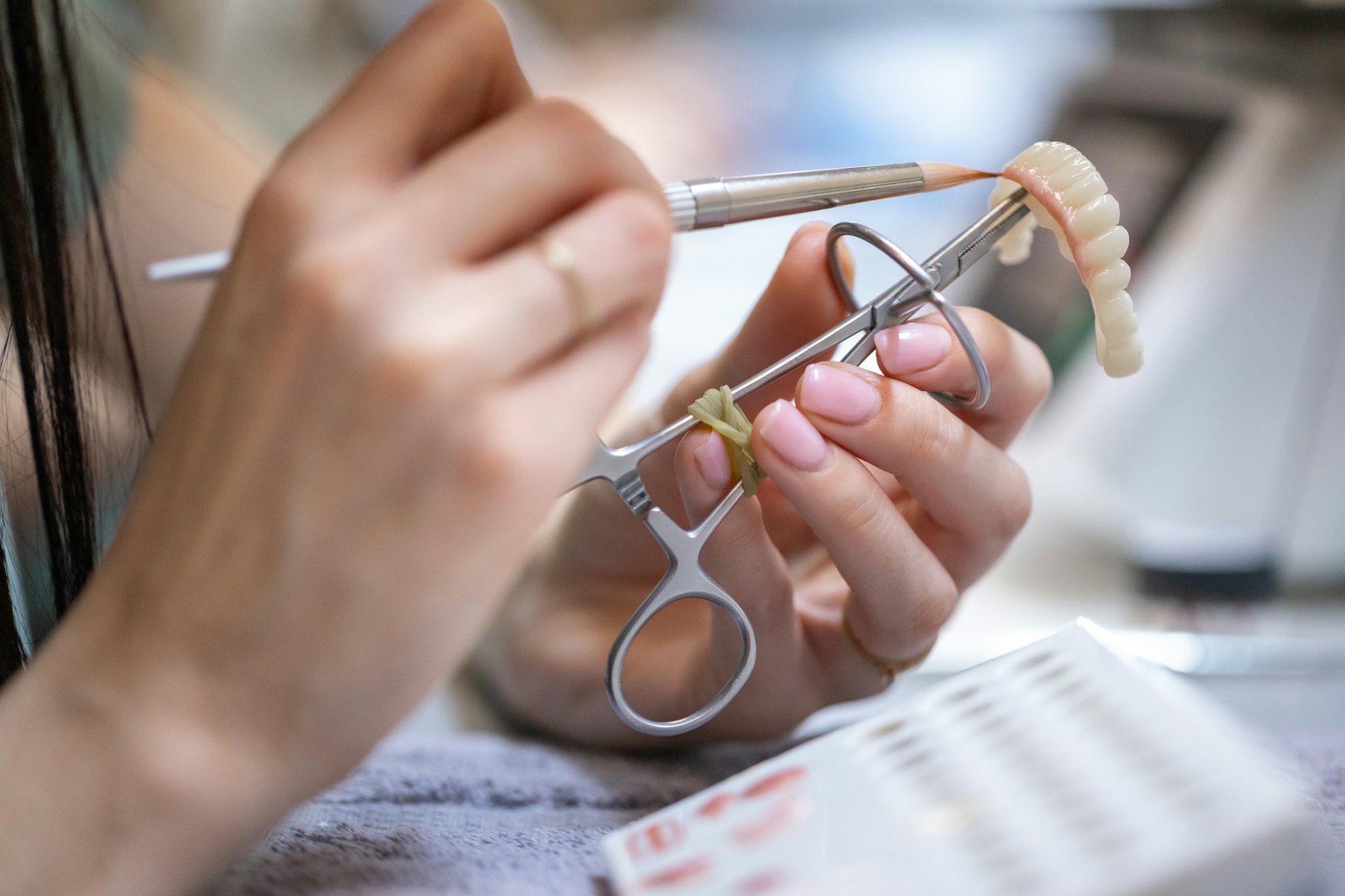 Dental technician hand-finishing a restoration